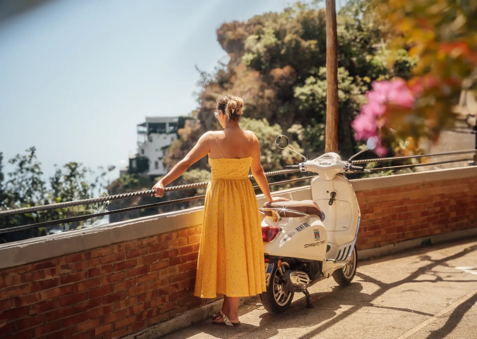 Young woman on Vespa exploring the Amalfi Coast
