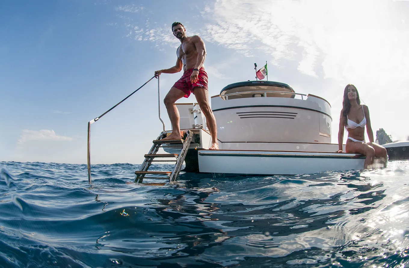 Couple swimming in crystal-clear sea during private boat tour on the Amalfi Coast