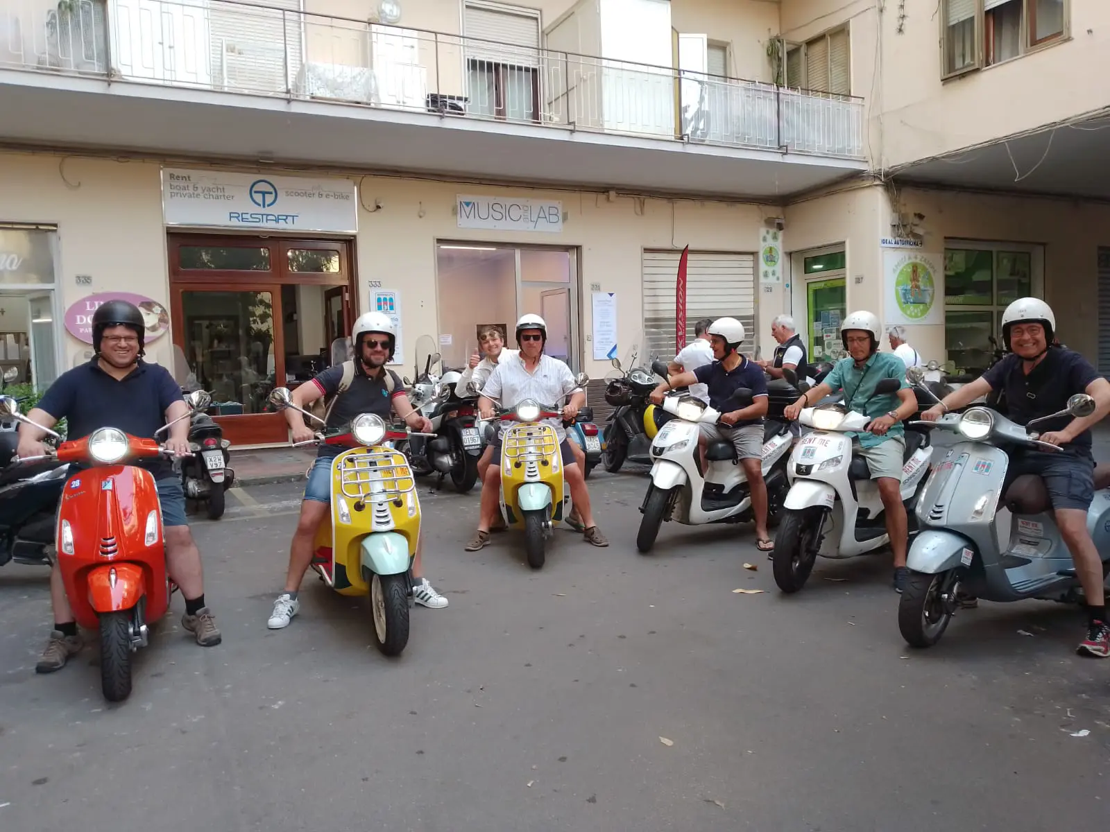 Group of friends on Vespa tour along Amalfi Coast
