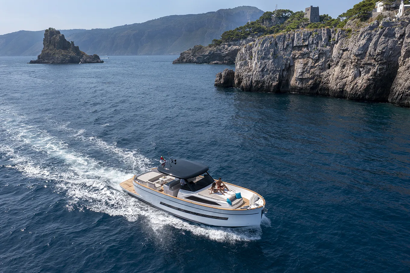 Tourists admiring the Amalfi coast while cruising near Li Galli Islands
