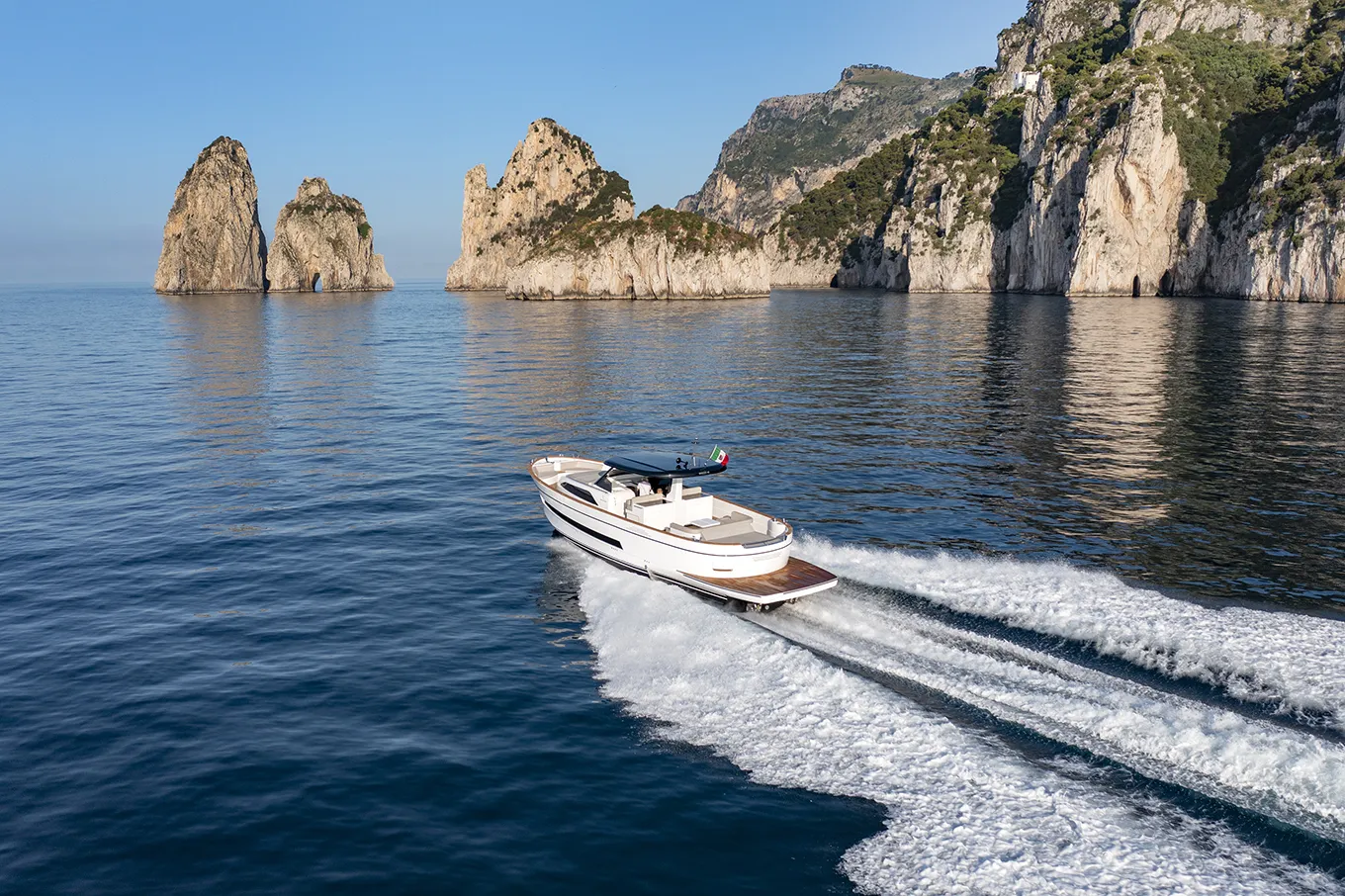Boat cruising through the turquoise waters of the iconic island of Capri