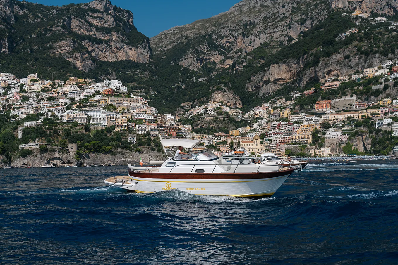 Skipper navigating a traditional boat during a boat tour on Amalfi Coast