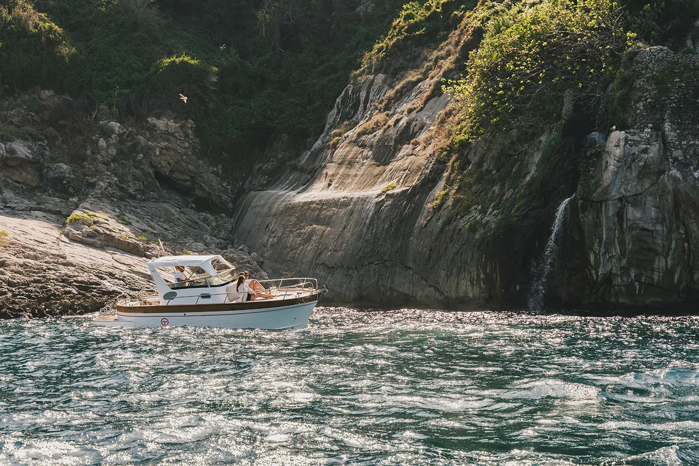 Skipper navigating along the Sorrento Coast with tourists on board