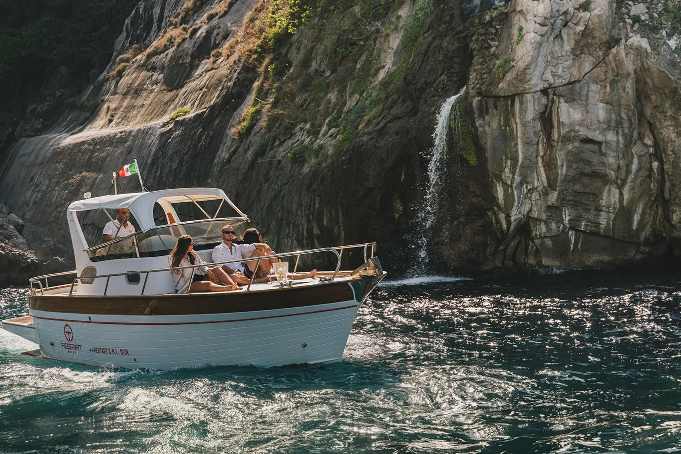 Group of friends relaxing on a boat off the coast of Sorrento