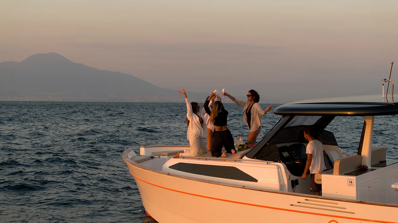 Group of friends toasting at sunset during a sunset boat tour from Sorrento