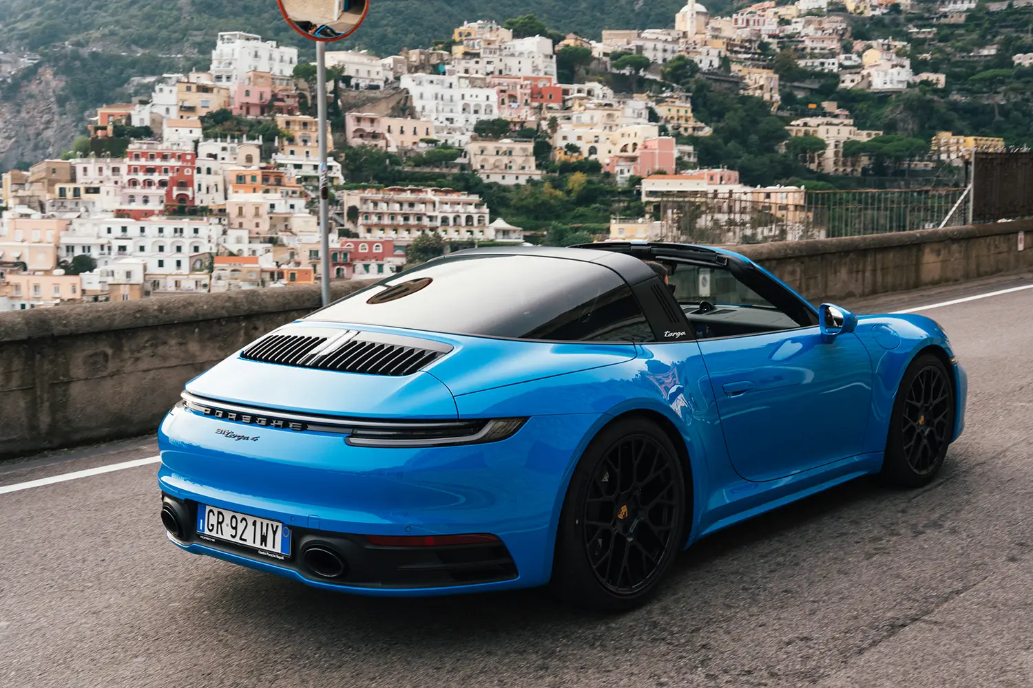 Side view of Porsche 911 on scenic coastal road