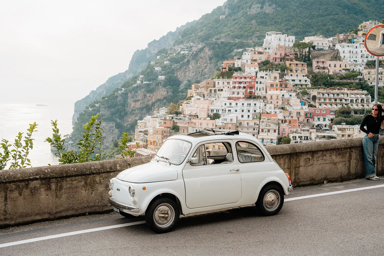 Classic Fiat 500 parked with sea view