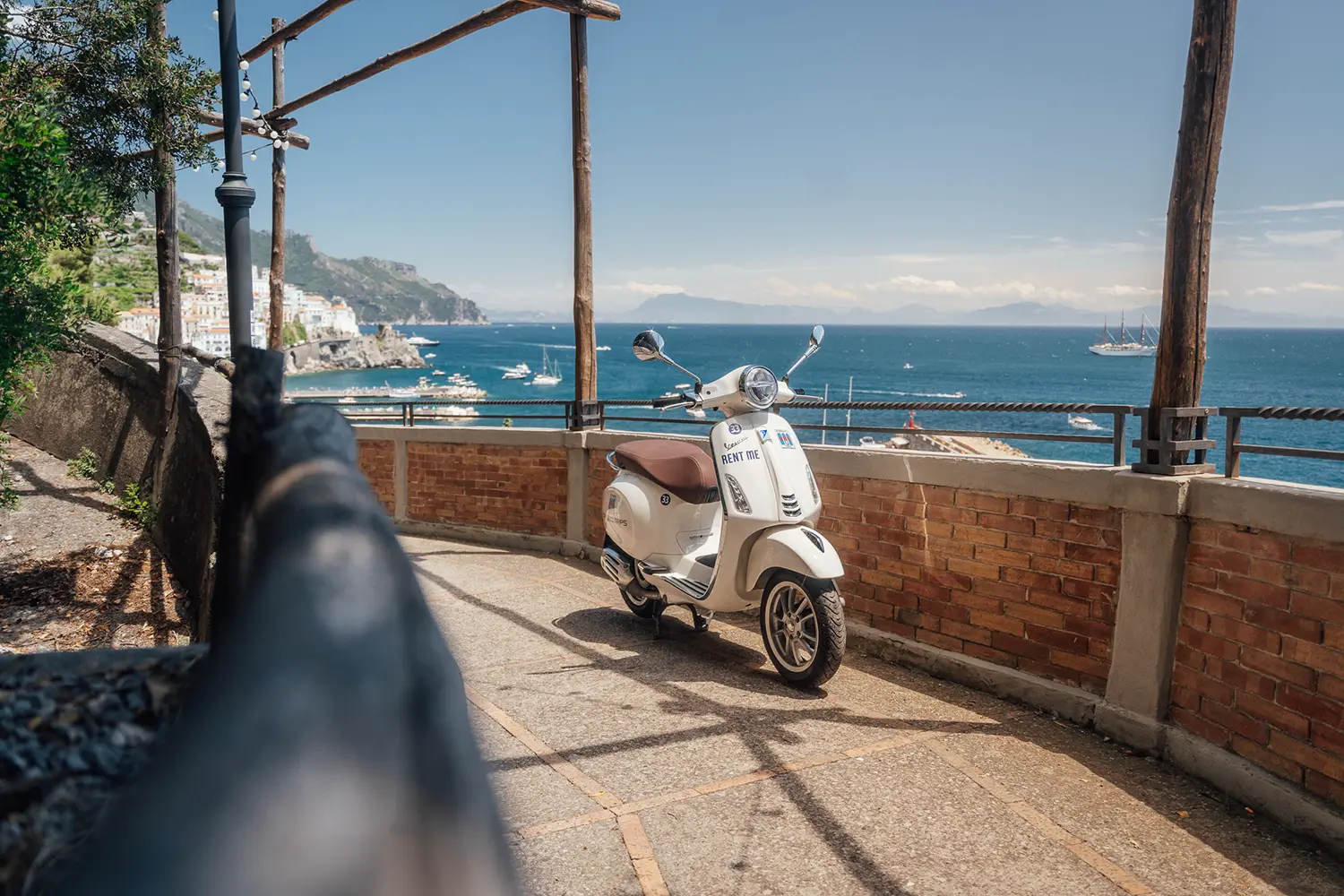 Colorful Vespa parked on scenic road of Amalfi Coast