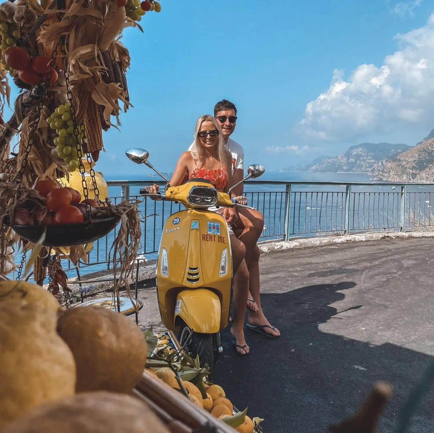 Couple enjoying Vespa tour in Amalfi Coast with sea view
