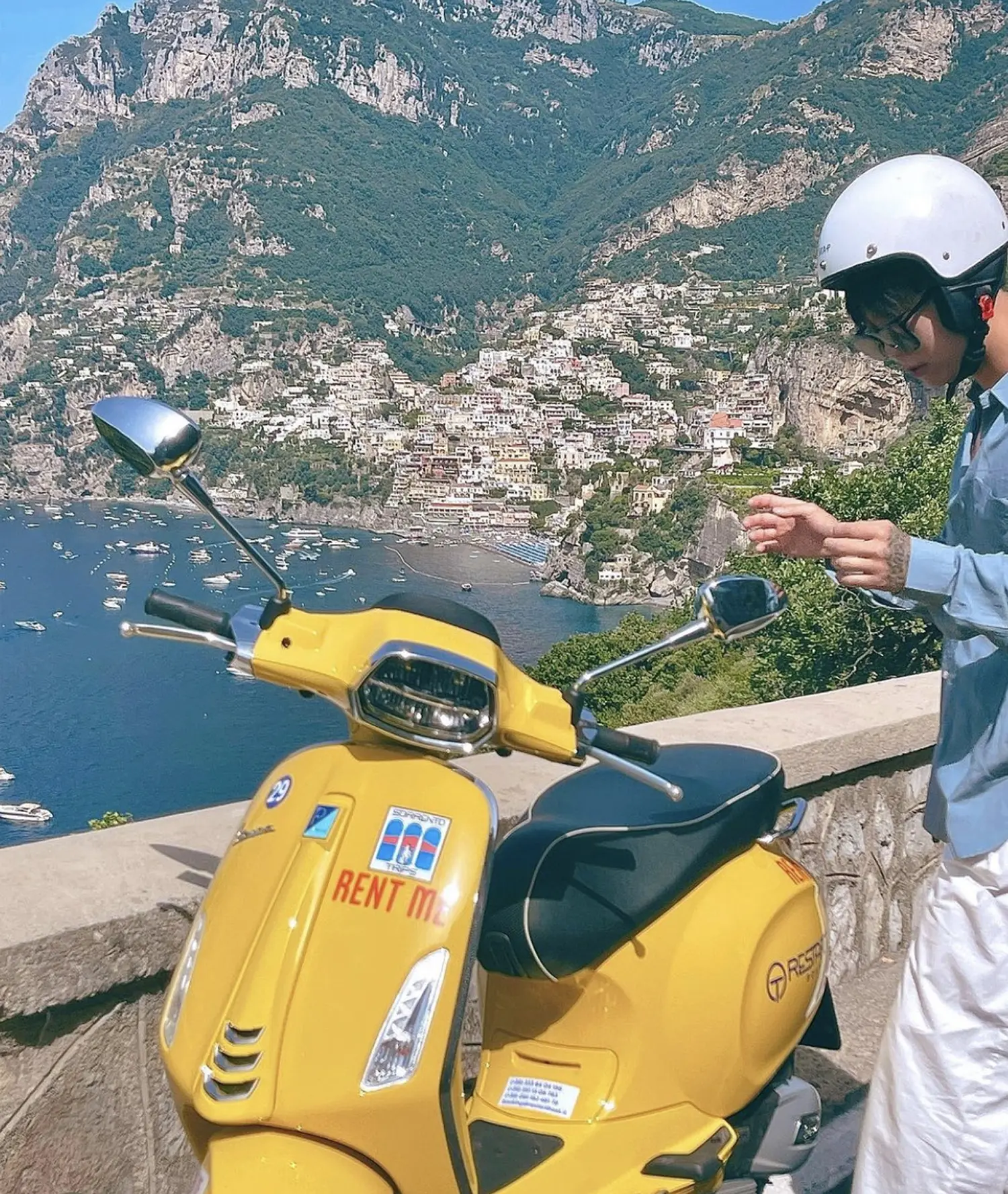 Colorful Vespa parked on scenic road of Amalfi Coast
