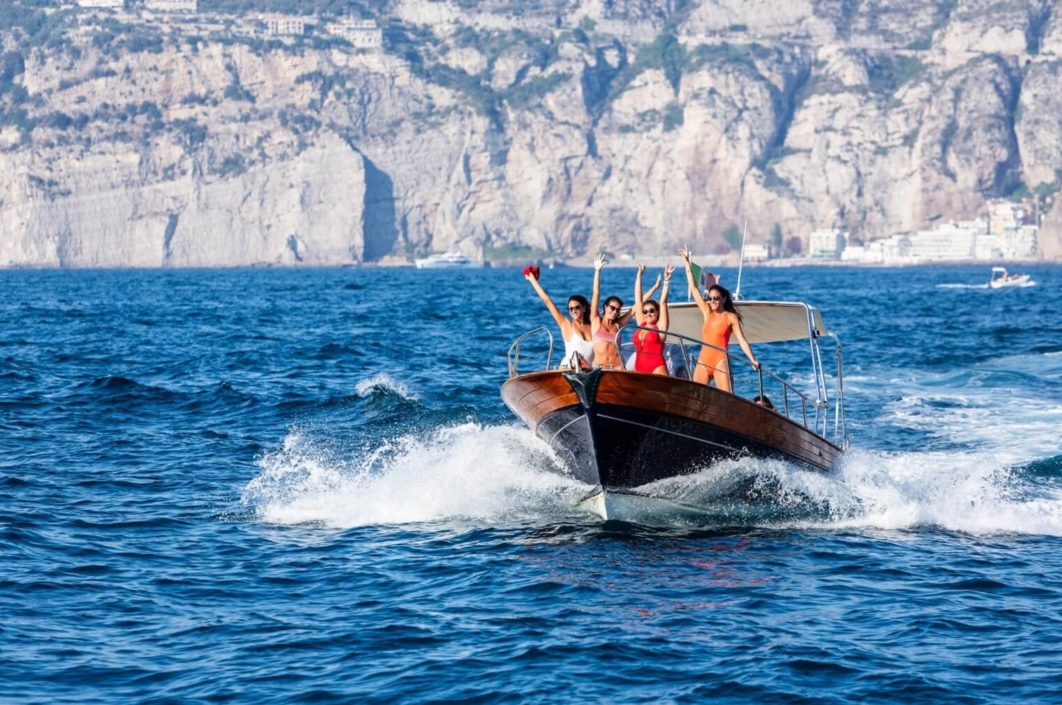 People on a boat wearing sunglasses enjoying the sun and sea